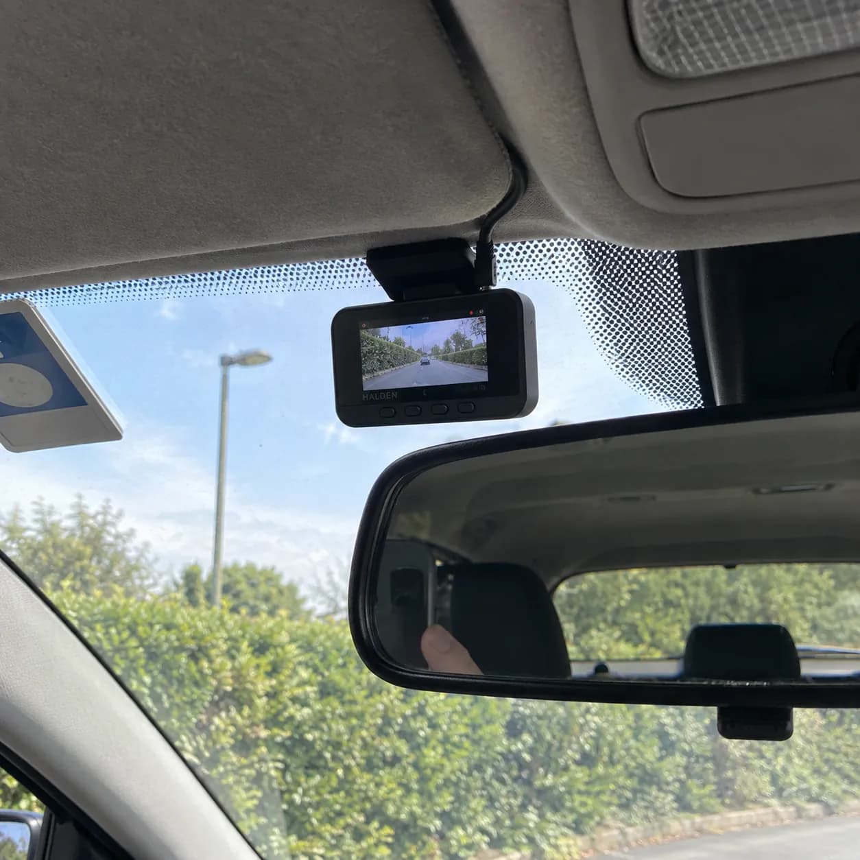 The Halden fitted behind the mirror with the cable tucked into the headliner
